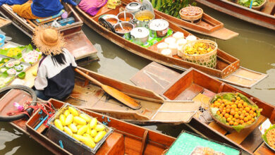 Wooden boats busy ferrying people at Amphawa floating market on April 13, 2011 in Bangkok. A traditional popular method of buying and selling still practiced in canals , Thailand.