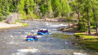 people on boats in river rapids