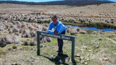 man leaning on a sign