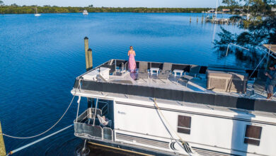 person standing on a house boat