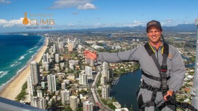 man standing on a skyline wearing a harness