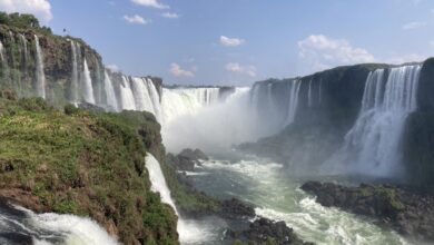 view of Iguazu Falls htundering over cliff from below